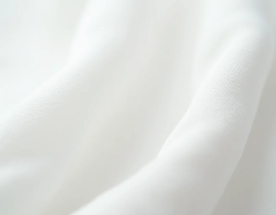 Close-up comparison of Supima cotton fabric texture versus regular combed cotton